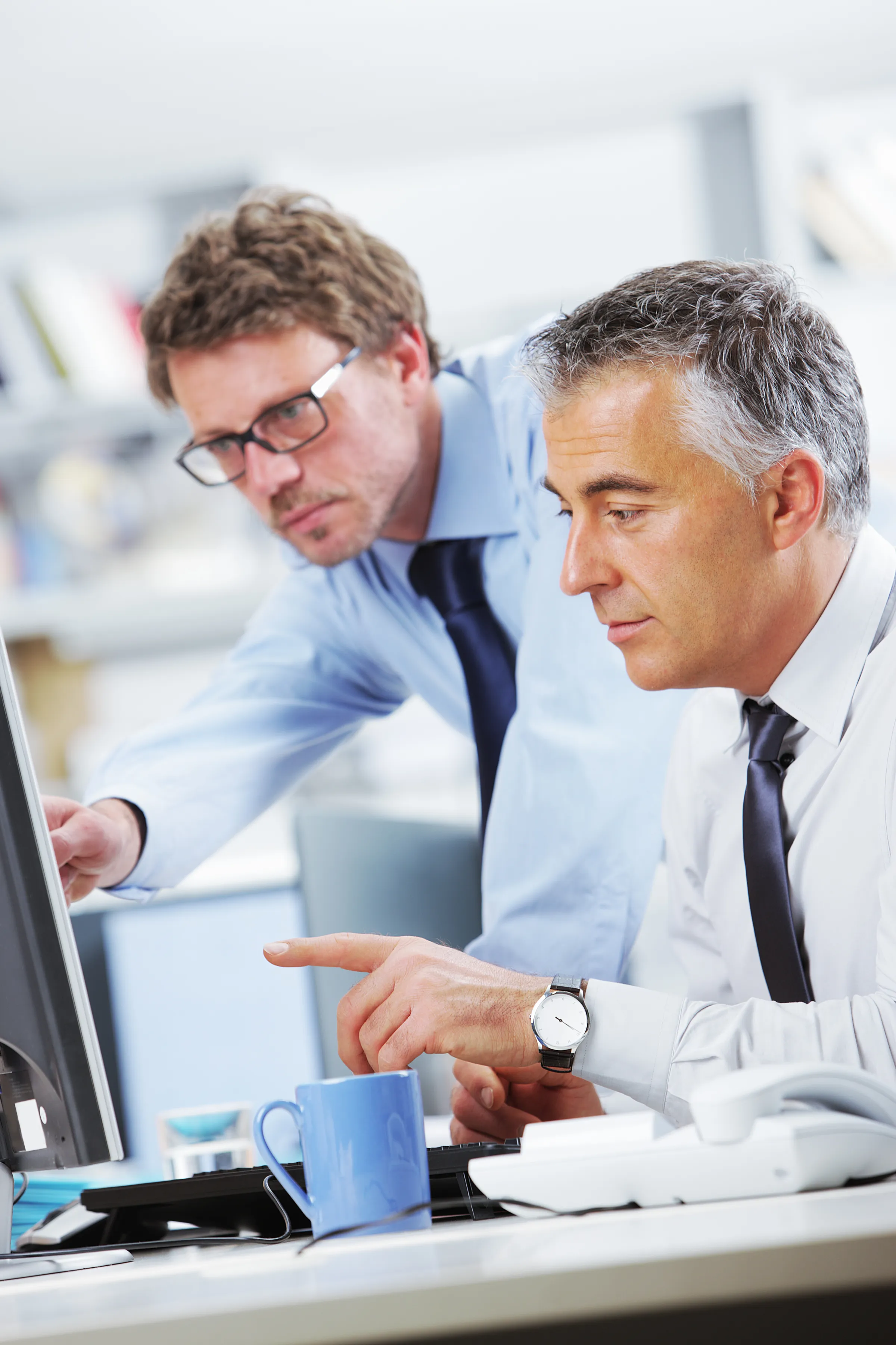 Business people in discussion at a computer